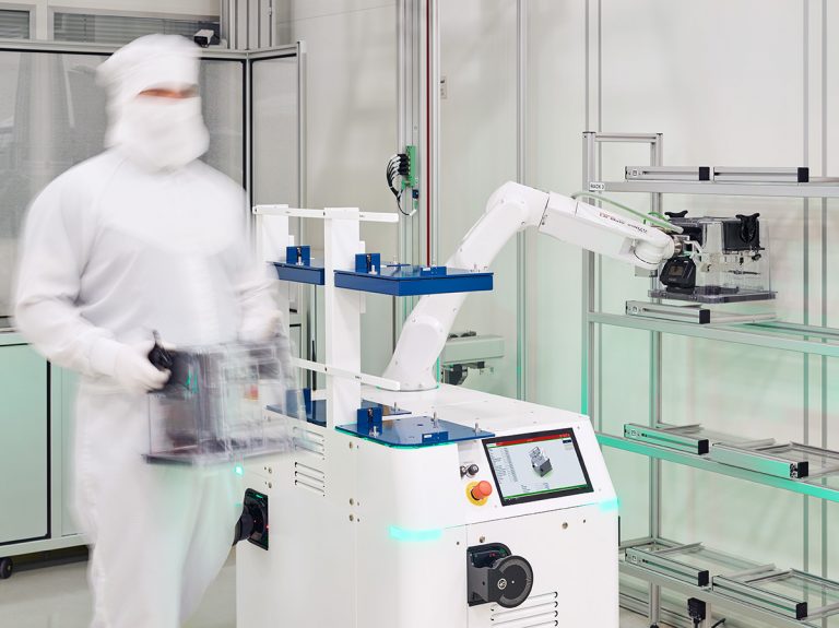 Automated Guided Vehicle (AGV) HERO FAB in the cleanroom handling and transporting wafers together with an operator